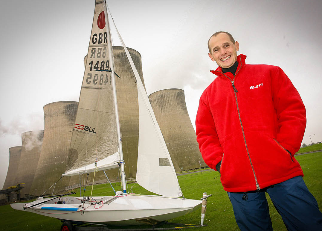 (Photo shoot 1006-035) Eon UK engineer Andy Smith pictured with his boat infront of the cooling towers at Ratcliffe Power Station.